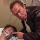 Arnold Schwarzenegger and his unconscious son